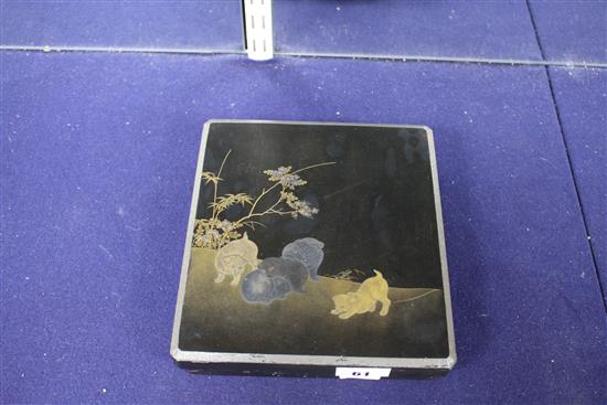 A Japanese Meiji lacquer writing box, the lid decorated with five puppies playing in a garden, underside of the lid with bird perched b